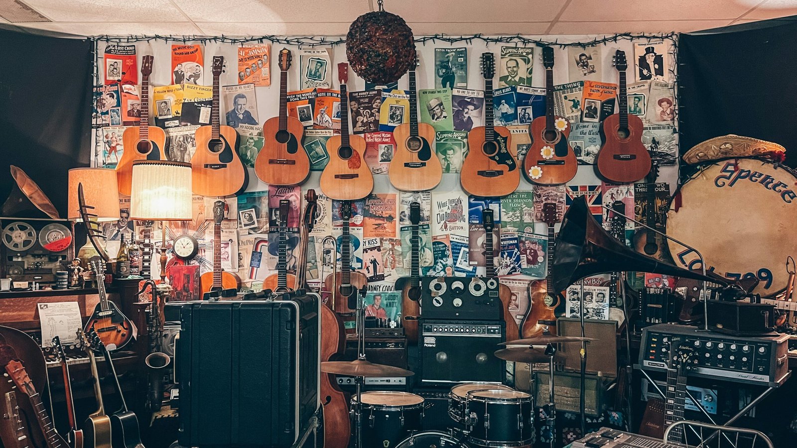 a room filled with lots of guitars and musical equipment