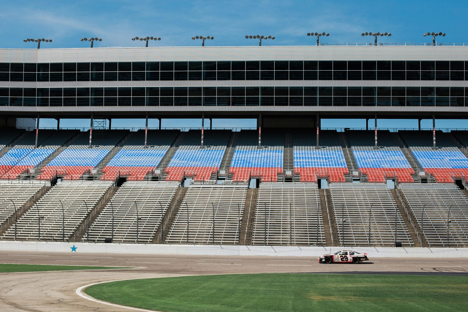 aerial photography of car on stadium under clear blue sky