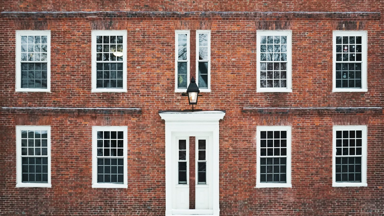 brown concrete building with white framed windows